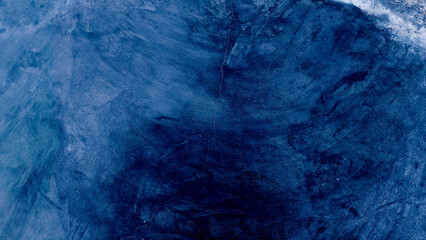 Dark blue grungy backdrop with golden splatters. Abstract dark blue concrete texture background.
