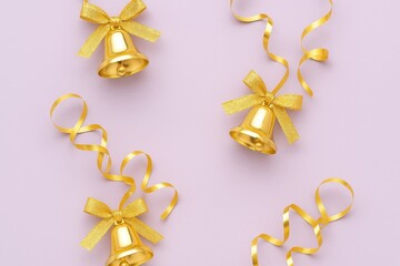 Festive golden bells with ribbons