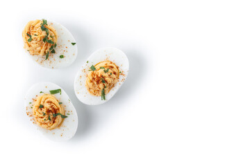 Homemade hard Boiled Deviled Eggs garnished with herbs isolated on white background. Top view