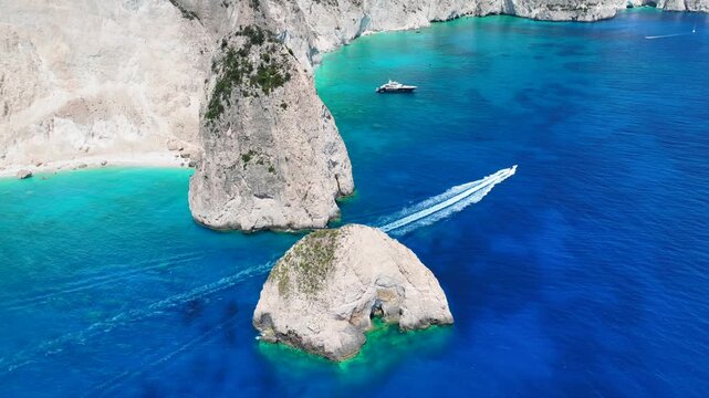 Aerial drone cinematic video from scenic viewpoint to small iconic islets of Mizithres a true paradise tourist place visited by yachts and sail boats in island of Zakinthos, Ionian Sea, Greece