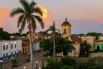 Bright sunrise over the historic colonial city of Trinidad with the bell tower. Cuba