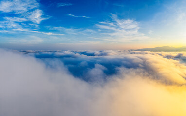 Spectacular sea of clouds and distant mountains under a dramatic sky at sunrise