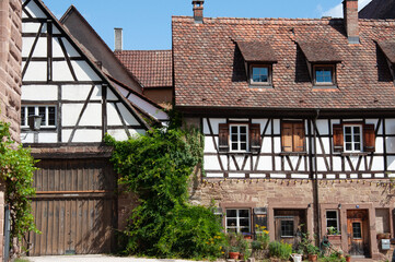 Medieval buildings in Maulbronn Monastery, half-timbered houses, wooden beams on facades, old European architecture, heritage site, historic courtyard, cultural tourism, traditional German style
