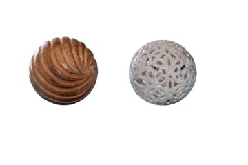 Decorative wooden sphere with spiral grooves and white ceramic openwork sphere on transparent background