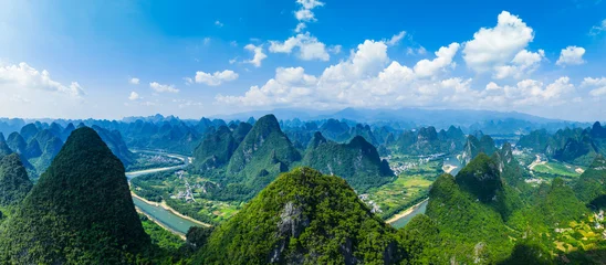 Fotobehang Blauwe hemel Aerial panoramic view of the famous karst mountain landscape and winding river on a sunny day in Guilin, China.  © ABCDstock