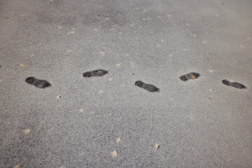 footprints of a passer-by on the first winter snow, background, surface texture