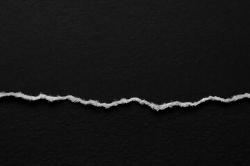 Torn paper on black background.