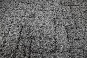 Winter texture of paving slabs covered with snow, top view, background surface in snow