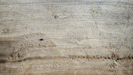 Rough wooden surface texture with natural grain and knots in light brown color
