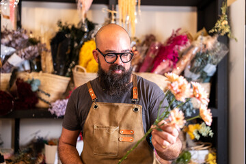 Florist entrepreneur arranging flowers in small business shop