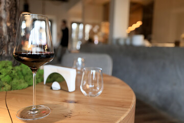 dinner in a restaurant with wine, beautiful table setting, a glass of wine in the foreground
