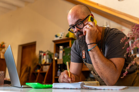 Florist owner talking on phone managing small business