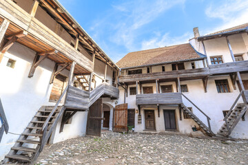 Prejmer fortified church courtyard with medieval stone church, multi-level defensive storage galleries and high surrounding walls, Transylvania. UNESCO site of Romania
