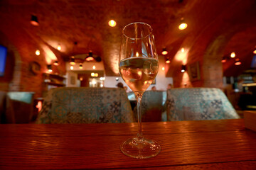 a glass of cold white wine and serving in the restaurant