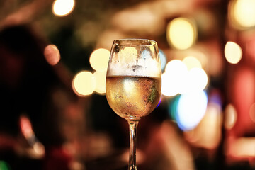a glass of white wine served in a restaurant, abstract background of a summer restaurant