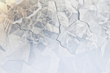 Obraz premium white winter background, frosty patterns on glass, abstract backdrop of ice and snow crystals in a blur