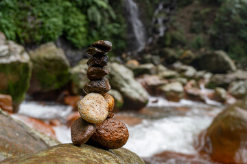 Balanced Rocks Serenity by the Waterfall in Lush Greenery.