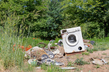 Abandoned Washing Machine on the ground in the countryside.