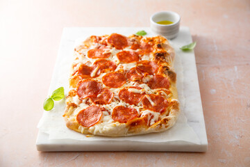 Traditional Pepperoni pizza with fresh basil