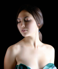 Elegant portrait of a young woman on a dark background.