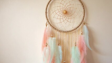 Hanging gold hoop dreamcatcher showcasing web pastel pink or mint or blue feathers against beige wal - Powered by Adobe