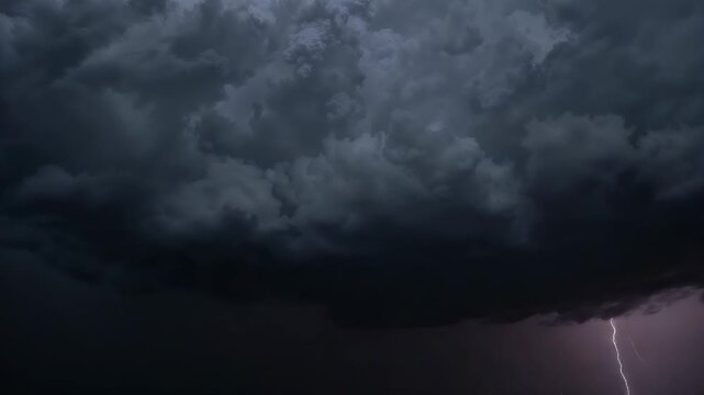 Flashing initial lightning bolt under cumulonimbus base, erupting lightning bolts over open plain