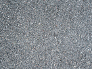 Asphalt surface background top view. Grainy road closeup. Dark gray grunge texture backdrop.
