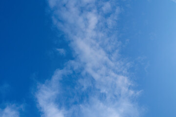 White clouds on blue sky. Fluffy cirrus clouds in summer sunny day. Nature cloudscape background.