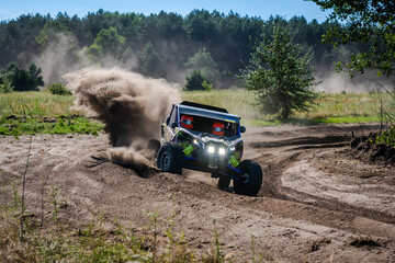 Fototapeta premium Cool view on UTV, rally, 4x4 riding in dusty track. Amateur competitions
