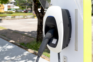 An electric vehicle charging station in an outdoor parking lot. An eco-friendly transport concept.