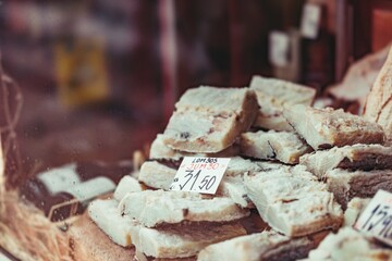 Chunks of salt cod are stacked, ready for sale. A price tag sits amongst them, offering this traditional Portuguese ingredient to eager customers in Porto