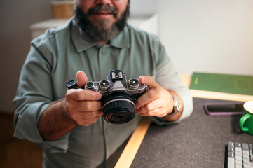 Man holding camera with both hands.