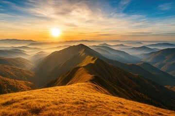 Naklejka premium Golden sunrise illuminates rolling mountain peaks shrouded in morning mist and fog with vibrant sky