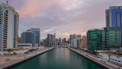 Obraz premium Dubai Marina towers and canal in Dubai night to day timelapse