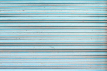 Obraz premium Old and dirty blue steel roller shutter door texture background