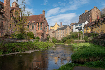 Naklejka premium Scenic view of Dean Village in Edinburgh, Scotland, showcasing historic buildings by the river.