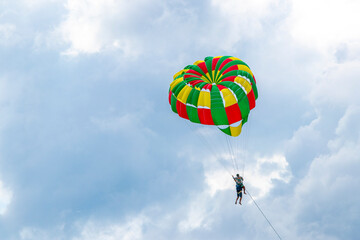 Patong Beach Phuket with parachute sport and parasailing activity Thailand.
