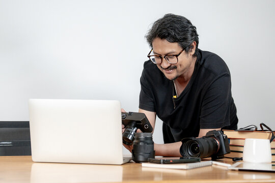 A young male photographer working on photo editing at his home studio, representing creativity, freelance work, digital art, and modern lifestyle.