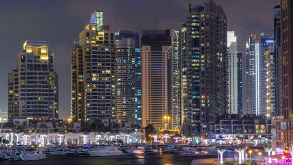 Naklejka premium Dubai Marina towers and canal in Dubai day to night timelapse