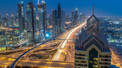Modern skyscrapers and busy evening highways day to night timelapse in luxury Dubai city, Dubai,...