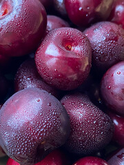 Red cherries freshly picked from the tree. Cherries drizzled with water drops.
