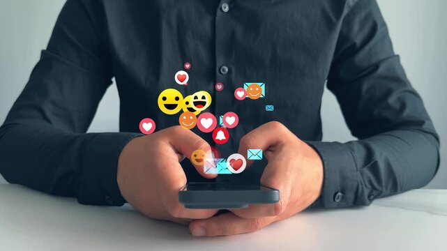 Interactive with friends on chat with emoticon feedback.Social media,marketing, like,social network,blog,live,chat reaction and livestream.Person using smart phone with emoticon icons of Social Media.