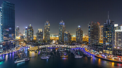 Fototapeta premium Dubai Marina skyscrapers aerial day to night timelapse, port with luxury yachts and marina promenade