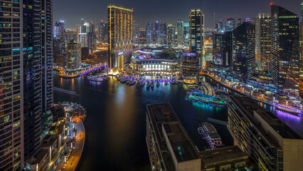 Naklejka premium Evening illumination of Dubai Marina day to night aerial timelapse, UAE.