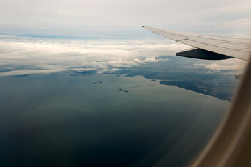 Aerial view trough passenger airplane window on final approach to Santos Dumont SDU Airport at Brazilian city of Rio on a cloudy spring day. Photo taken October 11th, 2025, Rio de Janeiro, Brazil.