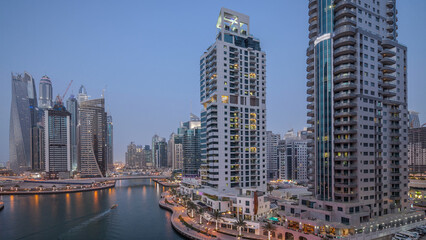 Obraz premium Beautiful aerial top view day to night transition timelapse of Dubai Marina canal
