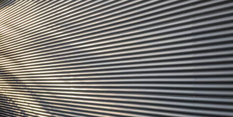 Fototapeta premium Corrugated Metal Wall Texture with Dynamic Shadows and Highlights
