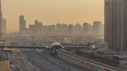 Aerial view of Jumeirah lakes towers skyscrapers during sunrise timelapse with traffic on sheikh zayed road.