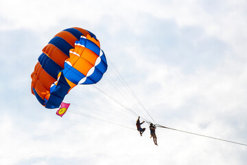 Patong Beach Phuket with parachute sport and parasailing activity Thailand.
