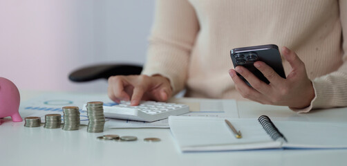 Financial Management. Calculating expenses with a smartphone and calculator.